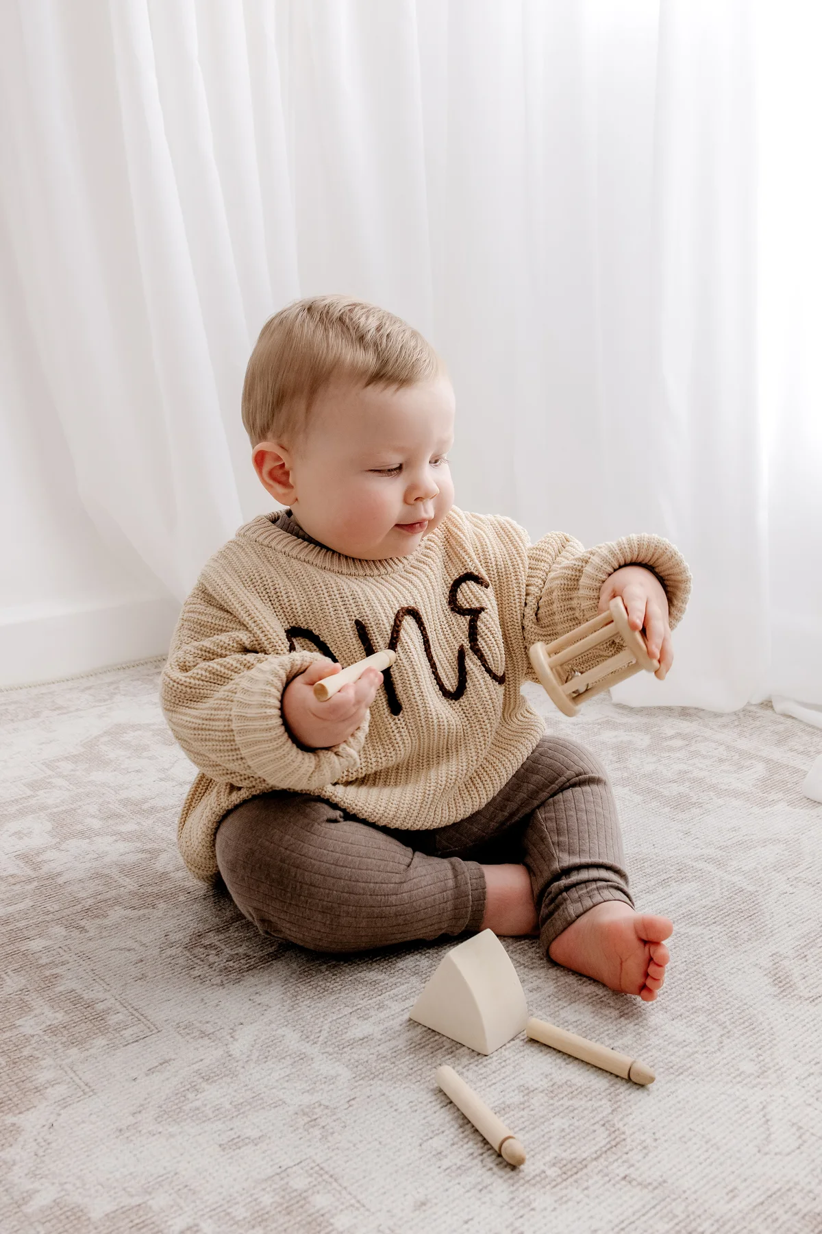 Baby sitting independently in a neutral studio